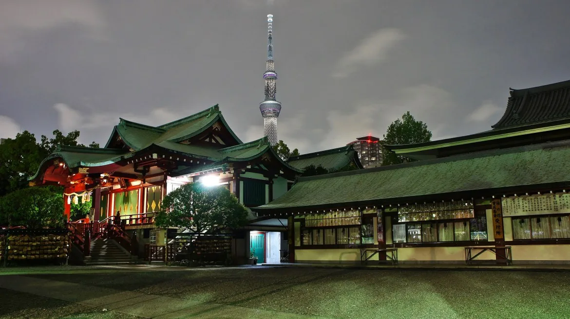 Kameido Tenjin Shrine at night with Tokyo Skytree behind it; lighting is seasonal